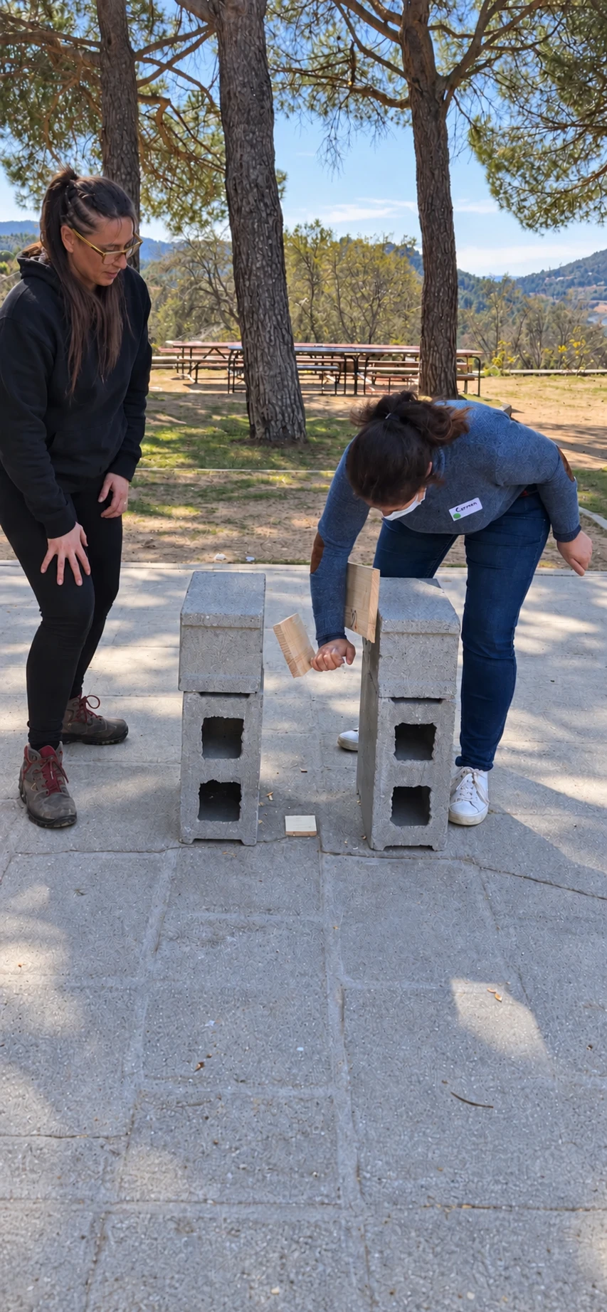 A participant breaks a board with support from a facilitator